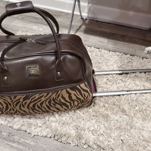 Tan and brown zebra print Liz Claiborne luggage. Adjustment handle with wheels